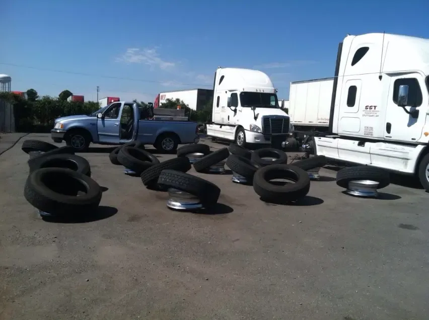 Large inventory of commercial truck tires and rims ready for fleet service at J&L Gonzalez lot in Arkansas