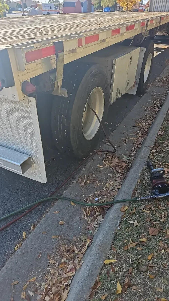 Roadside flatbed trailer tire repair with impact wrench and air compressor by J&L Gonzalez